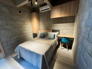 a bedroom with a bed in a brick wall at Our Home Granada in Cali