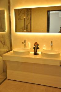 a bathroom with two sinks and a large mirror at THE LUGNT - Luxurious private villa surrounded by nature -  +18 photos