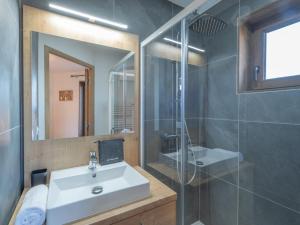 a bathroom with a sink and a shower and a mirror at Appartement neuf avec balcon et accès direct aux pistes, 3 chambres, Alpe d'Huez - FR-1-645-94 in L'Alpe-d'Huez +6 photos