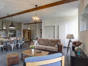 a living room with a couch and a table at Gîte lumineux avec terrasse et fibre optique, proche St Étienne - FR-1-496-370 in Saint-Paul-en-Jarez +15 photos