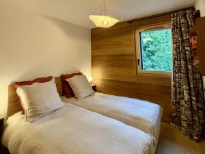 a bedroom with two beds and a window at Appartement 3 Chambres avec Terrasse et Parking à Arâches-la-Frasse, Animaux Bienvenus - FR-1-836-41 in Les Carroz d'Araches