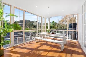 a balcony with a white table and large windows at Deluxe Queen Room at Wolfe Street in Whangarei