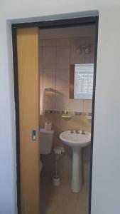 a bathroom with a sink and a toilet at Habitación en 25 in Veinticinco de Mayo