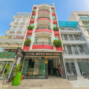 a tall white building with a hotel nococ floor mall at Ngọc Hoa Mai Hotel in Ho Chi Minh City
