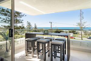 a bar on a balcony with a view of the ocean at Shara Seaside Oasis - Alex Beach 3BD Apartment in Alexandra Headland