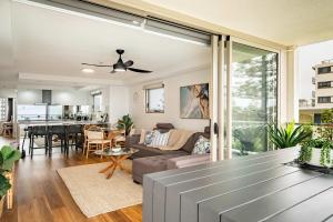 a living room with a couch and a table at Shara Seaside Oasis - Alex Beach 3BD Apartment in Alexandra Headland +28 photos