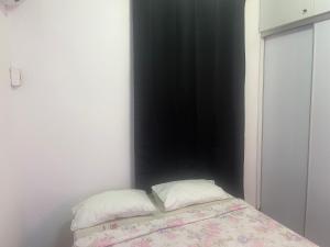 a bedroom with a bed with two pillows on it at Appartement Dream in Fort-de-France