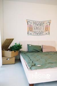 a bed in a living room with a sign on the wall at Chloe's Room 