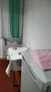 a room with a bed and a table and a window at квартира жубанова in Aktobe +2 photos