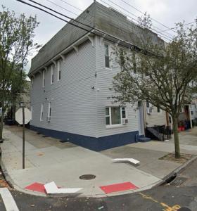 a white building with a gray roof on a street at Amazing private Room in Glendale