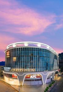 a large building with a lot of windows at Guangzhou Wogo Yuanbao Hotel-Zhujiang New Town-Free Canton Fair Shuttle Bus in Guangzhou