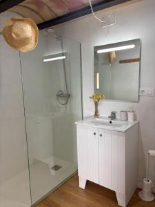 a white bathroom with a sink and a shower at Cabernet Rural in Sant Jaume dels Domenys