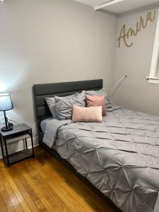 a bed with two pillows on it in a bedroom at The Lyons' Den in Chicago