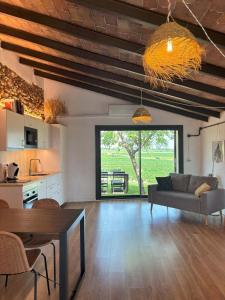 a living room with a couch and a table at Cabernet Rural in Sant Jaume dels Domenys