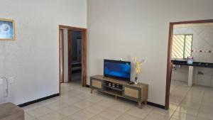 a living room with a television on a table at Large and comfortable house in the new Maraba - Folha 16 in Marabá