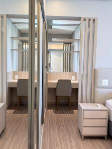 a room with a desk and a mirror at Savassi Luxury 2BR Pool and Home Office in Belo Horizonte +27 photos