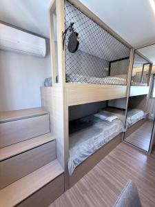 a room with two bunk beds in a room at Savassi Luxury 2BR Pool and Home Office in Belo Horizonte