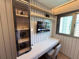 a small room with a white counter and a window at Savassi Luxury 2BR Pool and Home Office in Belo Horizonte
