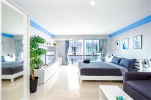 a bedroom with a bed and a living room at Hua Hin First-Hin Nam in Hua Hin