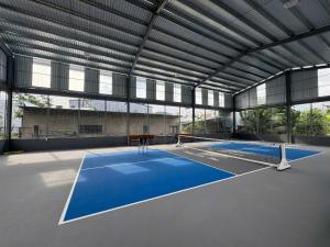 a tennis court in a large building with a tennis court at Villa Lien Tho in Phú Quốc