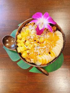 a bowl of food with a flower on top of it at ALOHADAYS Nishijin Guesthouse in Kyoto