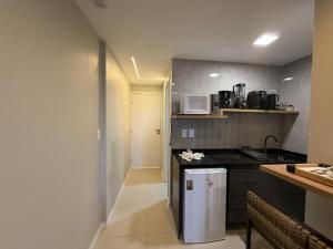a kitchen with a sink and a counter top at 509 Flat praia piscina barzinho Intermares in Cabedelo
