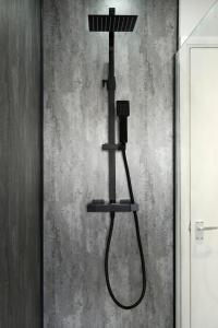 a shower with a hair dryer on a wall at 2 BDR Apt By Eason Stays Short Lets & Serviced Accommodation Denton Manchester With Free Parking in Manchester