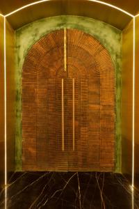 a room with a large door in a room at Jenneys Residency in Coimbatore +124 photos