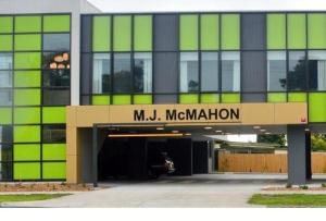a large building with a parking garage in front of it at MJ McMahon Motel in Wonthaggi +2 photos