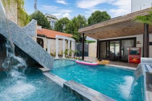 a pool with a slide and a water slide at Sun Villa Resort Mini - Trệt Không Lầu - Full Giải Trí in Vung Tau