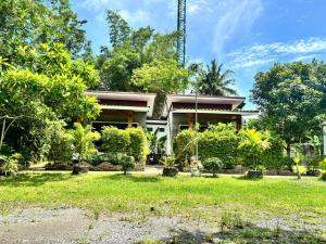 a house with a garden in front of it at Phra Ae Apartments in Ko Lanta