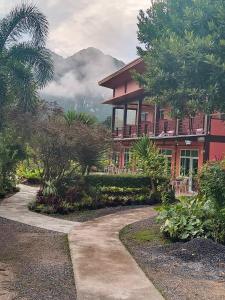a house with a walkway in front of it at Khao Sok Country Resort in Khao Sok