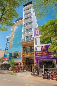 a hotel building with motorcycles parked in front of it at Royal Hotel Kangnam in Hanoi