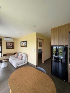 a living room with a couch and a table at The Costis Home in Phu Quoc