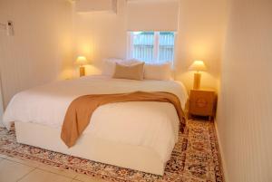 a bedroom with a large white bed and a window at Coastal Escape 3BR 2BA Family Retreat in Sellicks Beach +12 photos