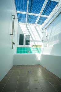 a bathroom with a shower and a tiled floor at Coastal Escape 3BR 2BA Family Retreat in Sellicks Beach