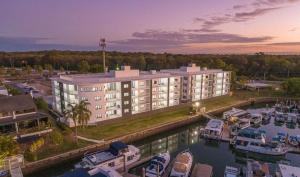 an aerial view of a hotel with boats in a marina at Marina Retreat in Sandstone Point