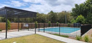 a black fence around a swimming pool in a yard at Marina Retreat in Sandstone Point