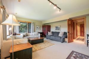 a living room with two couches and a table at Heron Chalet by Outpost Whistler in Whistler