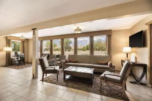 a living room with a couch and chairs at Best Western Frontier Motel in Lone Pine