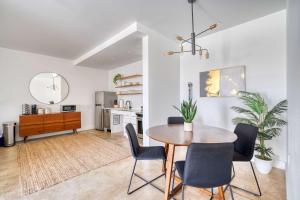 a kitchen and dining room with a table and chairs at Studio Bliss Dual-Queen Stay in Vibrant Alberta in Portland