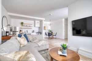 a living room with a couch and a table at Studio Bliss Dual-Queen Stay in Vibrant Alberta in Portland