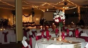 a dining room with a table with red and white chairs at Magnuson Grand Conference Hotel in Cypress Gardens