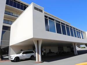 a white car parked in front of a building at Magnuson Grand Conference Hotel in Cypress Gardens