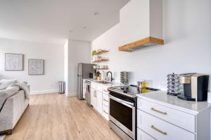 a kitchen with white cabinets and a stove top oven at Stay Portland - City Serenity- Stylish 2-Bed Alberta Haven in Portland