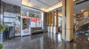 a lobby of a store with a staircase in it at Yiwu Guomao Hotel in Yiwu