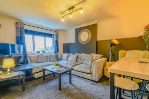 a living room with a couch and a table at 2 BR House By Eason Stays Short Lets & Serviced Accommodation Chester With Free Parking in Chester +19 photos