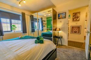 a bedroom with a large bed and a mirror at 2 BR House By Eason Stays Short Lets & Serviced Accommodation Chester With Free Parking in Chester
