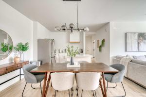 a kitchen and dining room with a wooden table and chairs at N Portland Condo - Walk to Food Bars Music in Portland