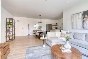 a living room with a couch and a table at N Portland Condo - Walk to Food Bars Music in Portland